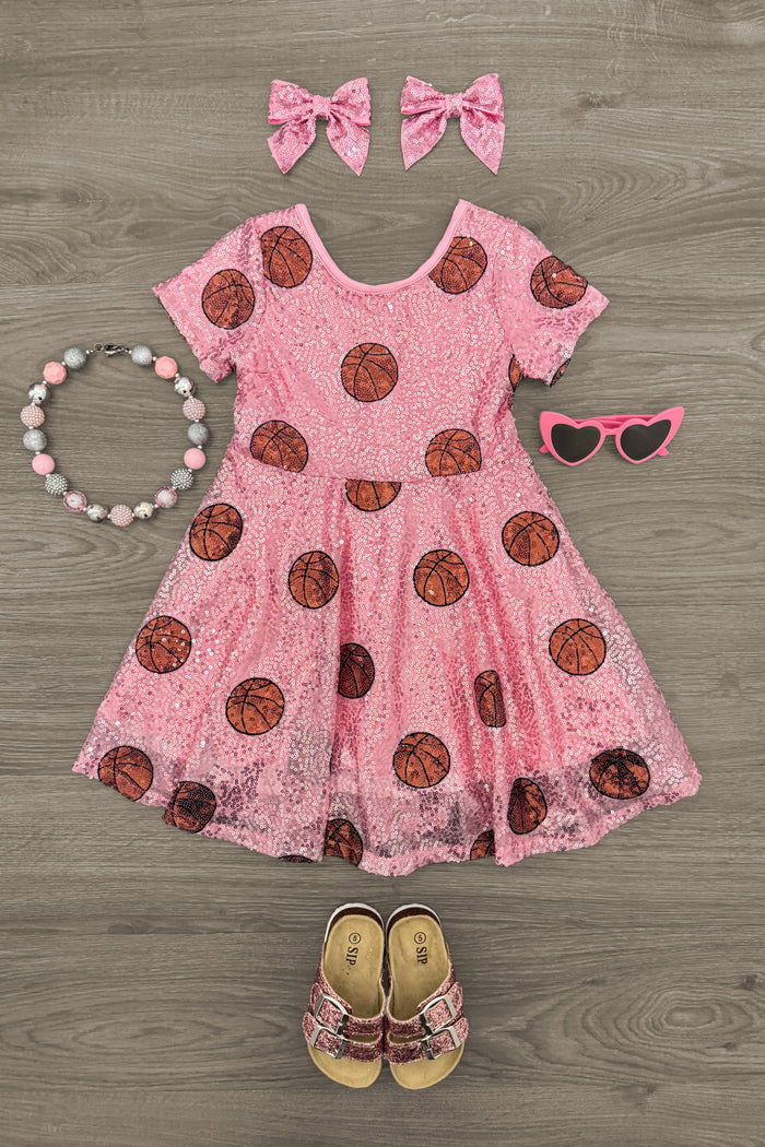 Pink Sequin Basketball Dress - 3XS-6-12 Months - Pink sequin dress with basketball patterns, matching pink bow hair clips, beaded necklace, pink sunglasses, and toddler.
