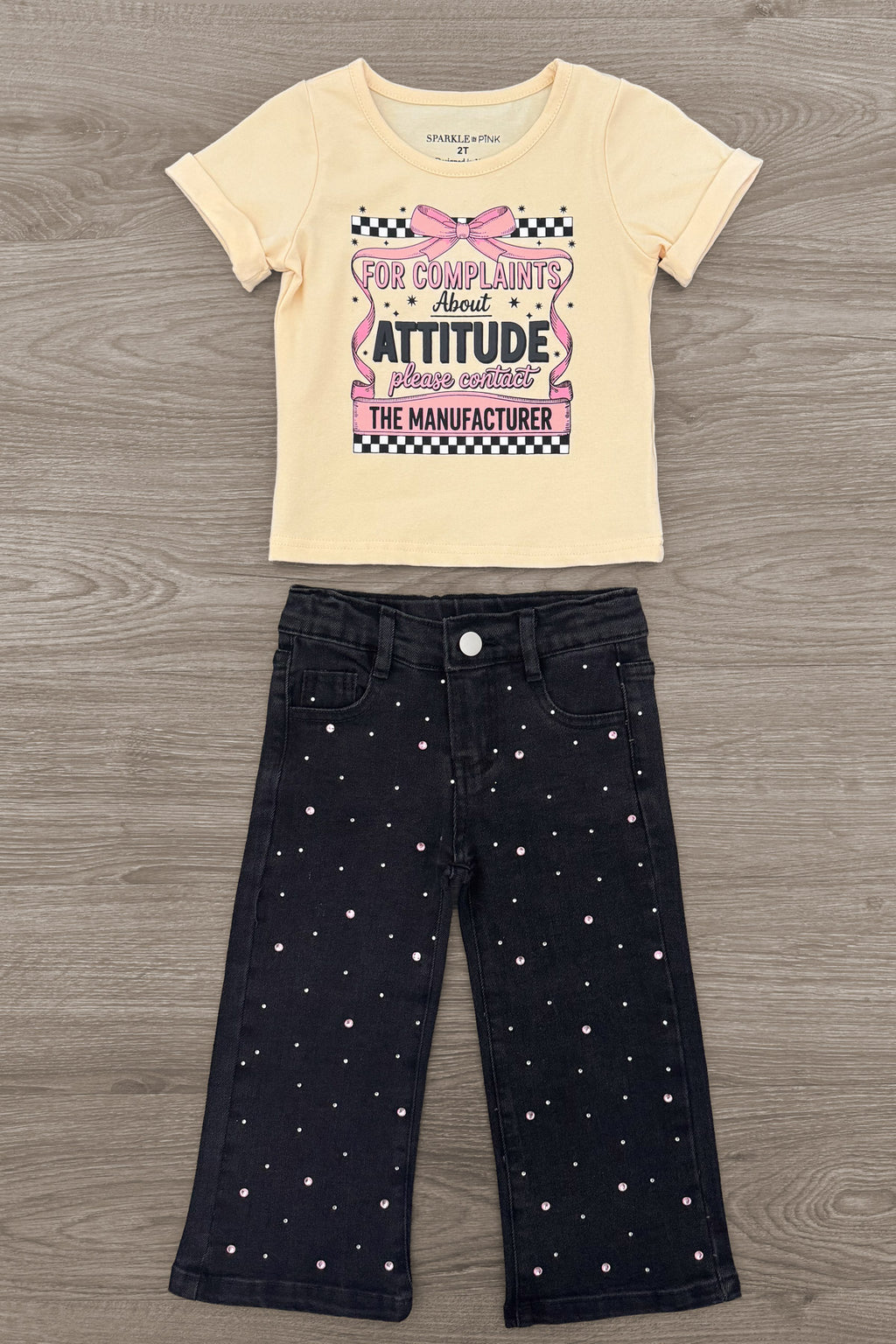 "For Complaints About Attitude.." Denim Pant Set - 6-12 Months - Cream short-sleeve t-shirt with graphic text paired with black denim pants featuring small white polka dots.