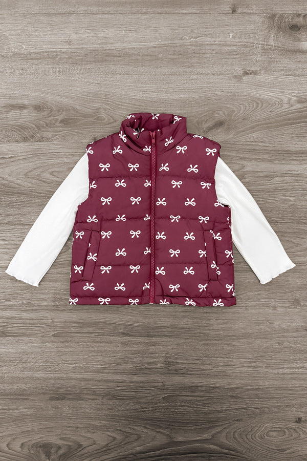 Mom & Me - Bow Vest Set - CHILD-6-12 Months - Burgundy quilted vest with white bow print layered over a long-sleeve white shirt on wooden floor background.