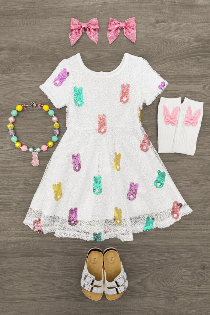 White Sequin Peep Dress - 3XS-6-12 Months - White short-sleeve dress with multicolored sequin bunny appliques and scalloped hem, paired with white leg warmers, pink.