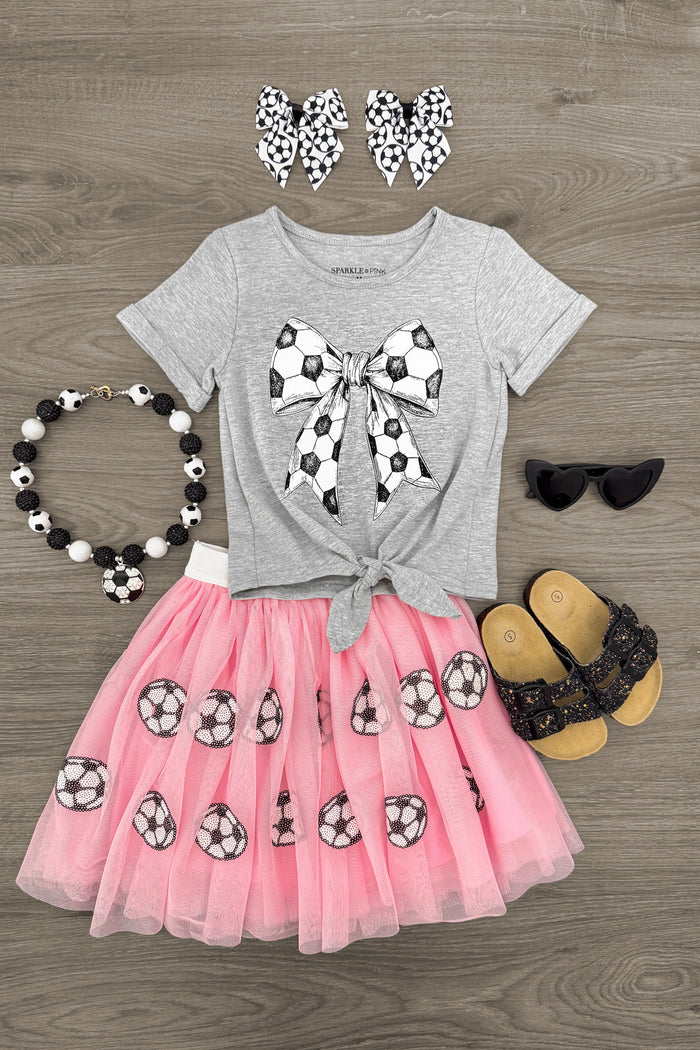 Pink Sequin Soccer Tutu Skirt Set - 3XS-6-12 Months - Gray short-sleeve shirt with soccer ball bow graphic paired with pink sequin tutu skirt and black sunglasses.