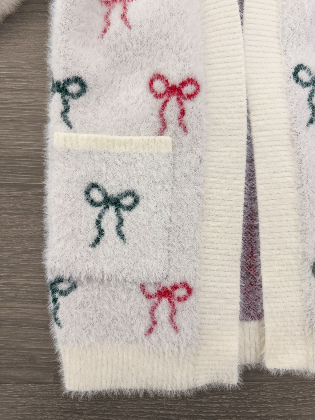 Mom & Me - Cozy Red & Green Bow Cardigan - CHILD-6-12 Months - Cozy cream cardigan with soft texture, featuring small red and green bow patterns and a front pocket.