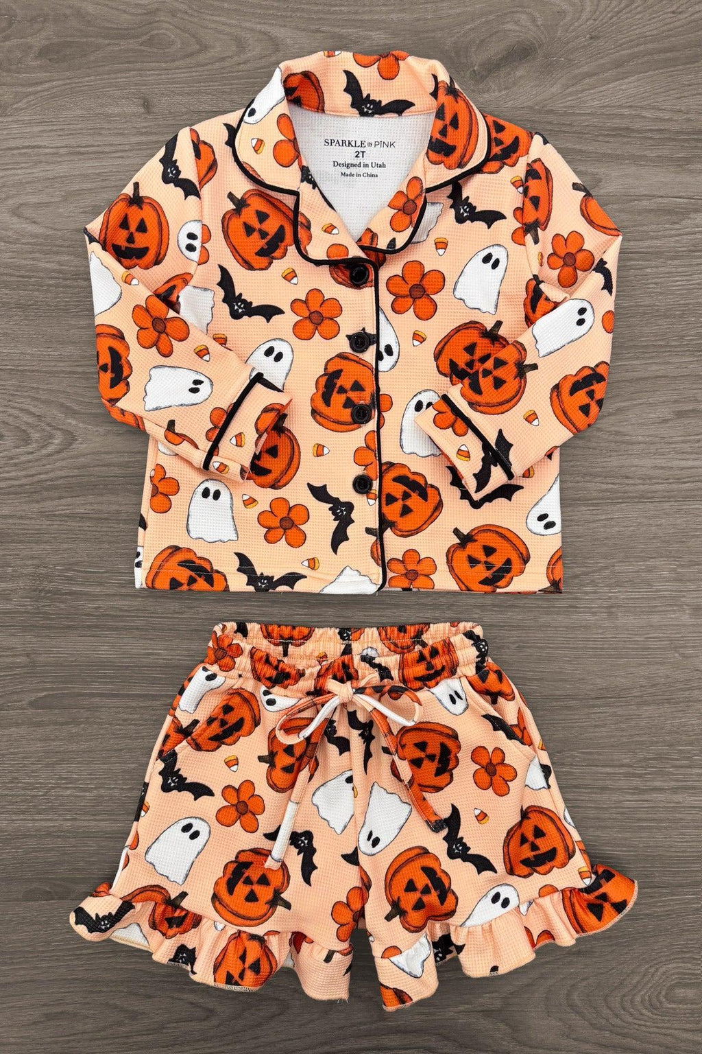 Mom & Me - Halloween Waffle Knit Pajamas - CHILD-6-12 Months - Orange waffle knit pajamas with black trim, featuring smiling pumpkin and ghost patterns, long-sleeve top and ruffled shorts.