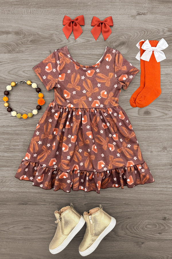 Pumpkin Pie Glitter Dress - 6-12 Months - Brown glittery short-sleeve dress with pumpkin patterns and ruffled hem, paired with brown boots, orange socks with white.