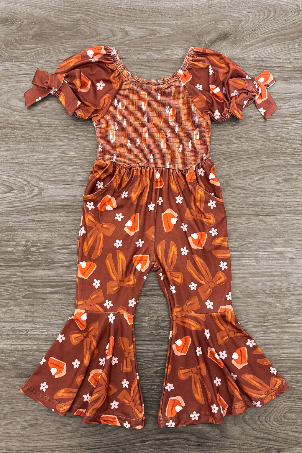 Pumpkin Pie Bell Bottom Jumpsuit - 6-12 Months - Brown bell bottom jumpsuit with puffed sleeves, floral print, and gathered waist and cuffs.