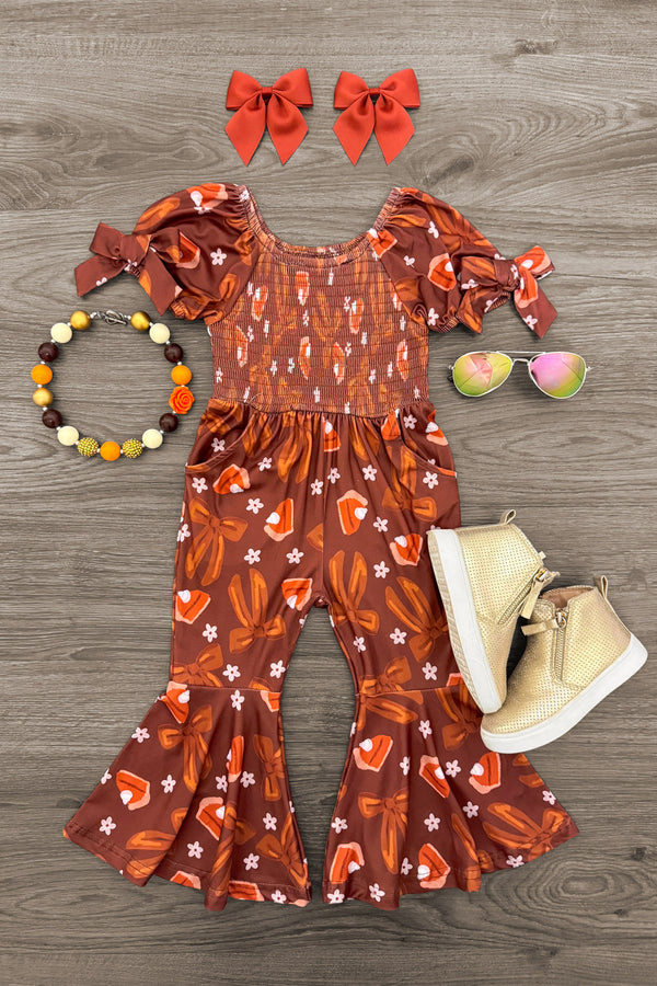 Pumpkin Pie Bell Bottom Jumpsuit - 6-12 Months - Brown bell bottom jumpsuit with white and orange pumpkin patterns, puffed sleeves, and smocked bodice, paired with beige.