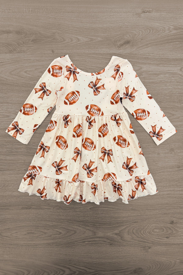 Football Bow Dress - 6-12 Months - Cream long-sleeve toddler dress with football print and ruffled hem.