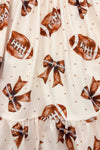 Football Bow Dress - 6-12 Months - Cream fabric dress with tan football and bow print featuring small brown polka dots.