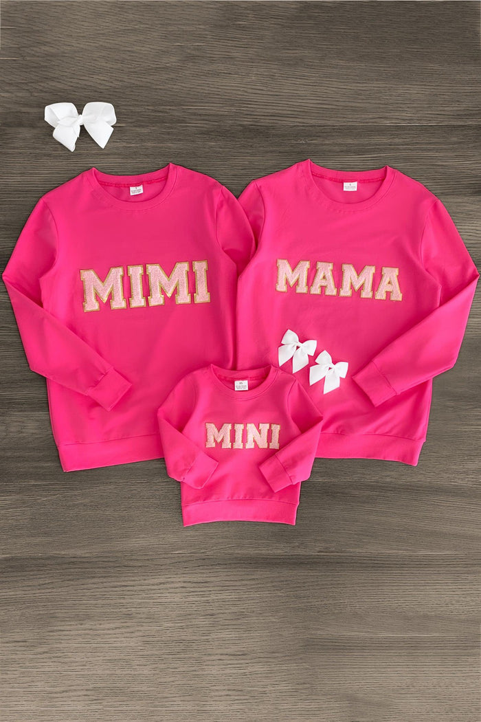 Mom & Me - "Mimi, Mama & Mini" Pink Chenille Patch Top - Child / BABY-0-3 Months-FAMILY - Three pink chenille patch sweatshirts with "MIMI," "MAMA," and "MINI" text, plus three white hair bows on wooden background.