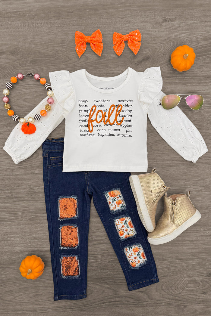 "Fall" Pumpkin Denim Pant Set - 6-12 Months - White long-sleeve top with orange "fall" text paired with dark blue denim pants featuring orange pumpkin patches and beige.