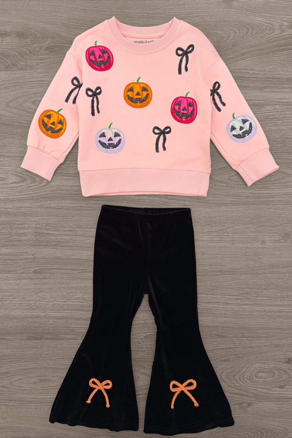Jack O' Lantern & Bows Velvet Flare Set - 6-12 Months - Pink velvet sweatshirt with colorful Jack O' Lantern faces and black bow appliqués paired with black velvet flare pants.