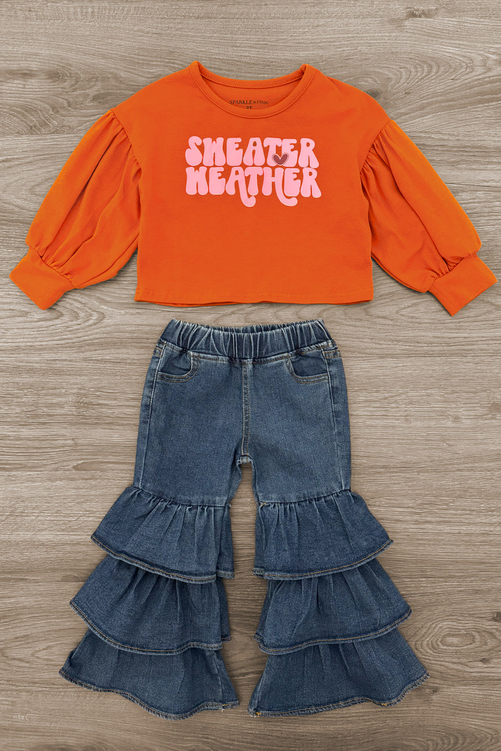 "Sweater Weather" Denim Bell Bottom Set - 6-12 Months - Rust orange cropped sweater with puffed long sleeves and white "Sweater Weather" text paired with layered denim bell bottom.