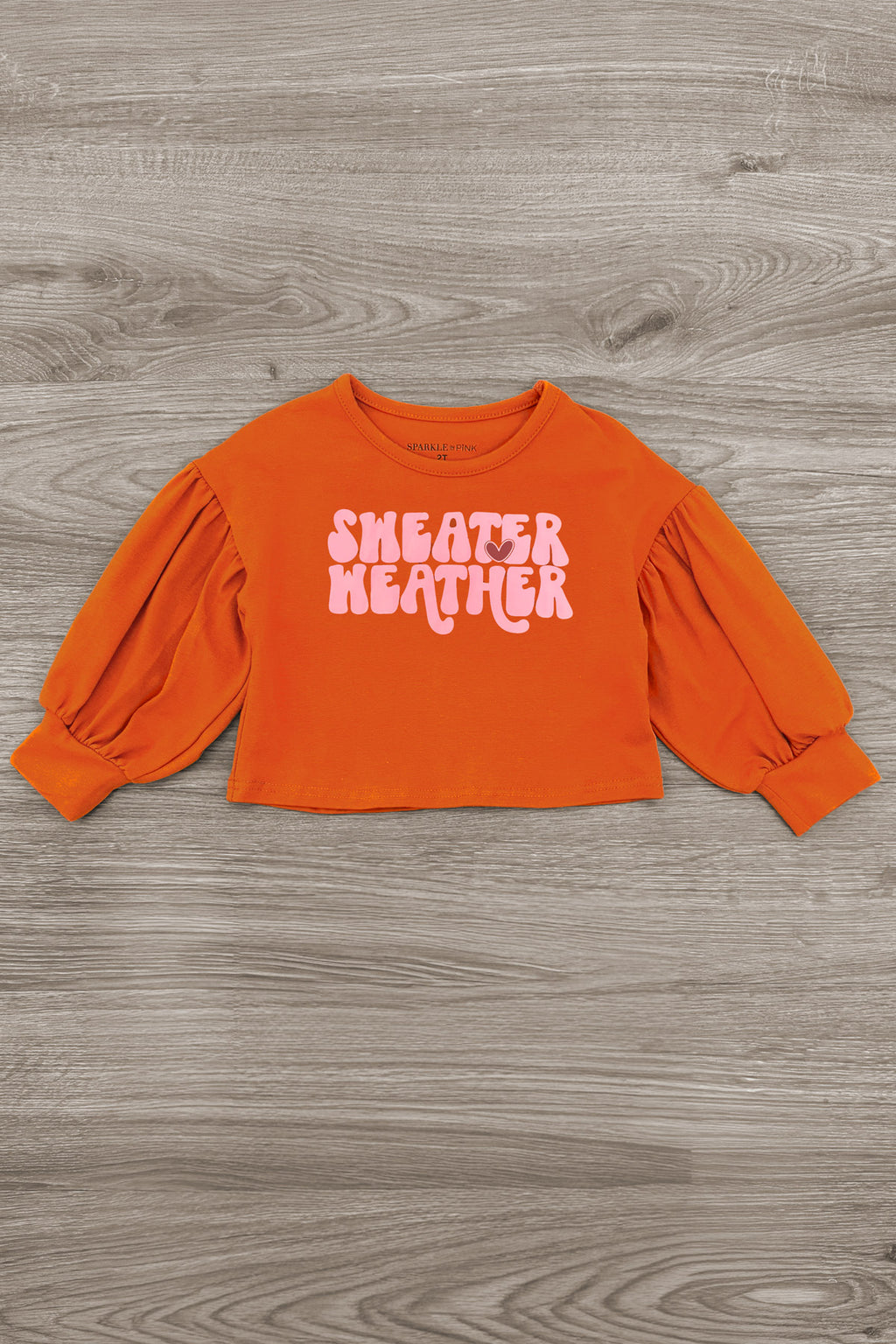 "Sweater Weather" Denim Bell Bottom Set - 6-12 Months - Rust orange denim cropped sweater with puffed long sleeves and white "Sweater Weather" text on front.