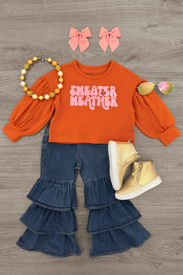 "Sweater Weather" Denim Bell Bottom Set - 6-12 Months - Rust orange long-sleeve crop top with "Sweater Weather" text paired with dark blue tiered denim bell bottom pants, cream.