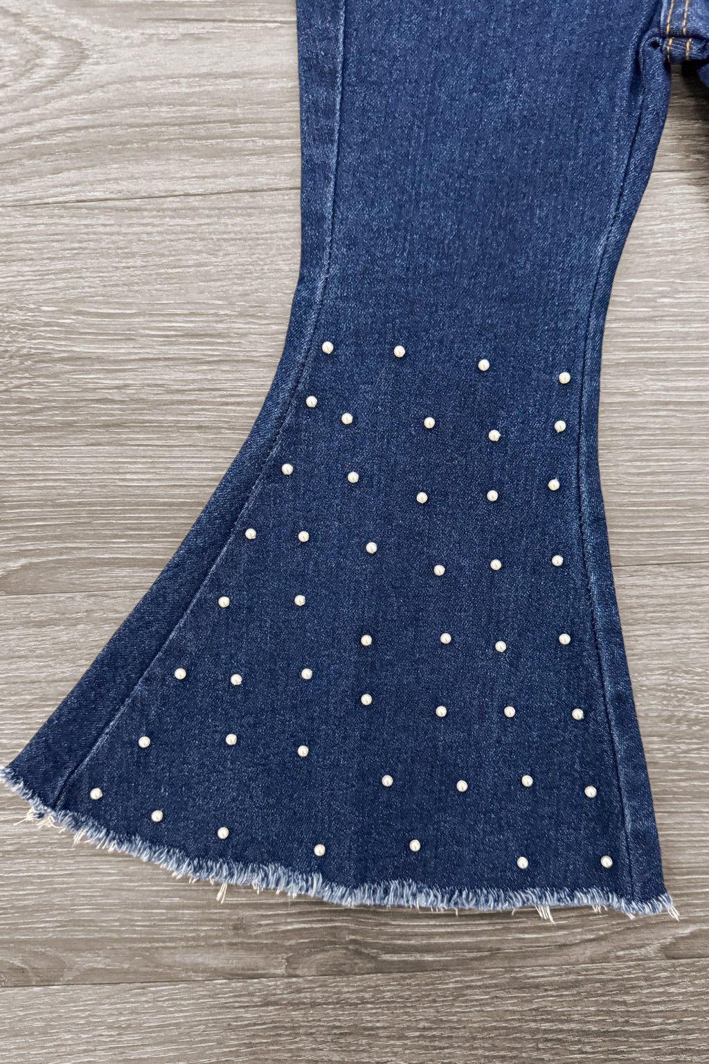Pearl Denim Bell Bottom Pants - 6-12 Months - Blue denim bell bottom pants with pearl embellishments and raw hem detailing.