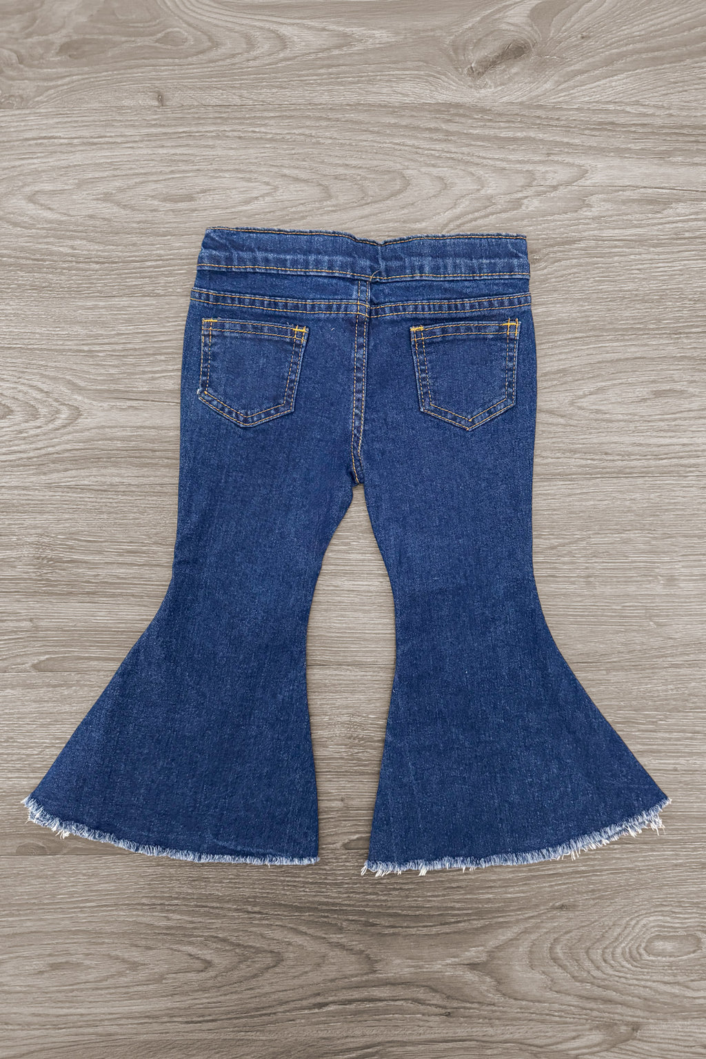 Pearl Denim Bell Bottom Pants - 6-12 Months - Mid-blue denim bell bottom pants with back pockets and raw frayed hems.
