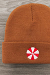 Gingerbread Beanie - 6-12 Months - 4T - Rust-orange knit beanie with folded cuff and red-and-white peppermint candy patch on front.