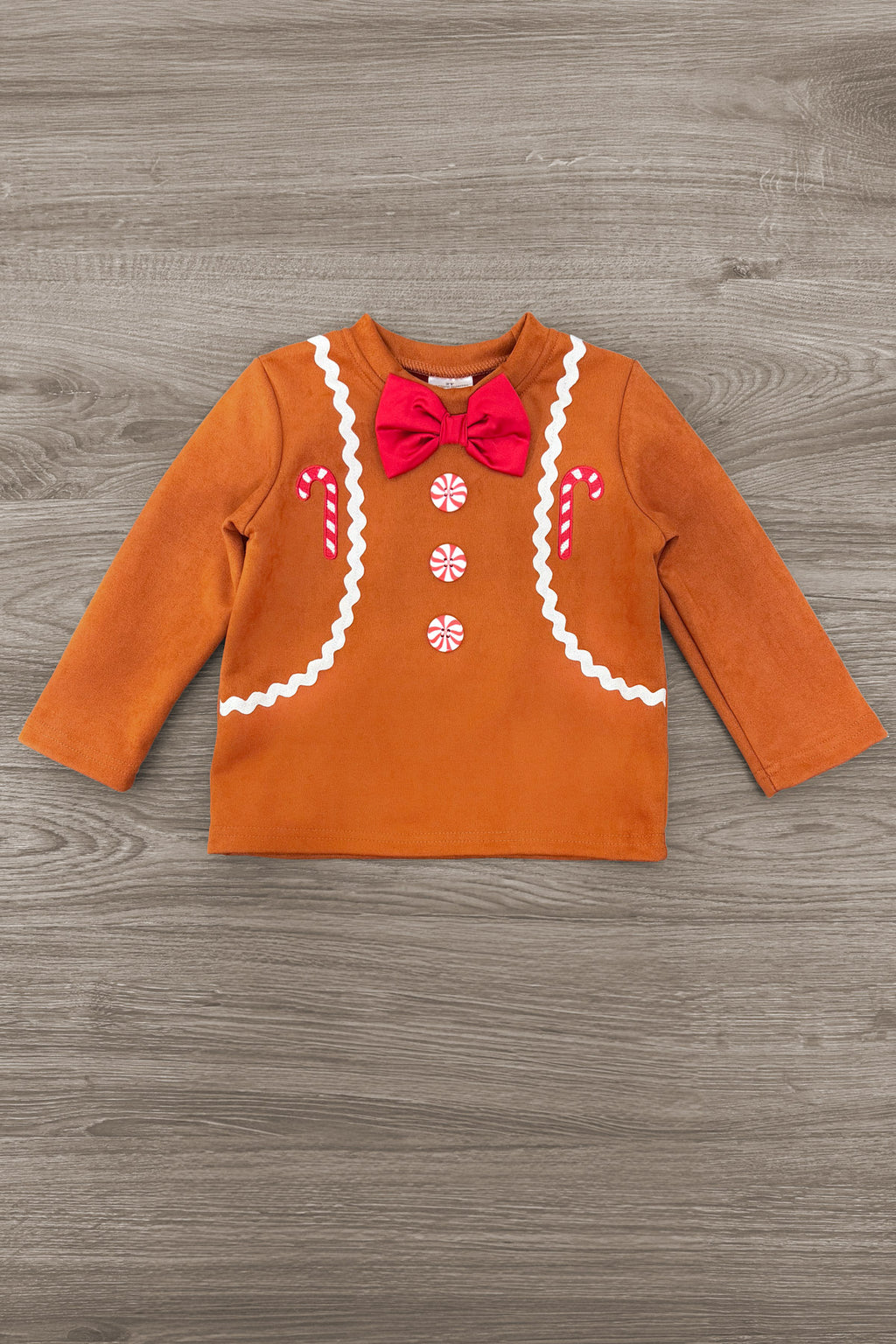 Gingerbread Man Costume - 6-12 Months - Orange long-sleeve toddler shirt styled as a gingerbread man with white icing trim, three white buttons, and a red bow tie.