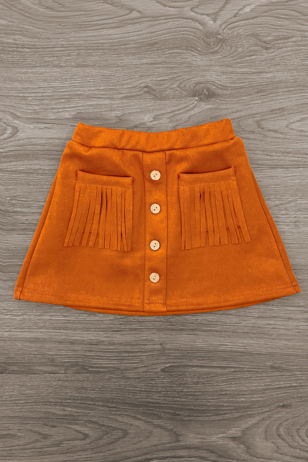 "Lil' Bit Rowdy" Suede Skirt Set - 6-12 Months - Orange suede mini skirt with button front and fringe-accented patch pockets.