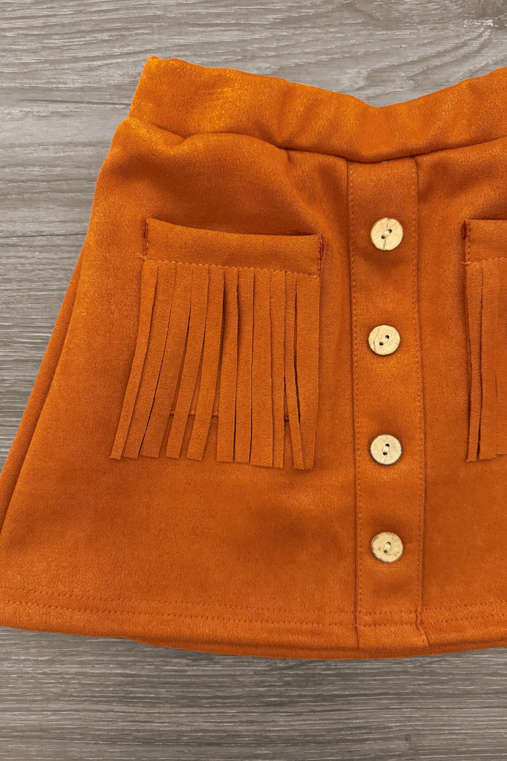 "Lil' Bit Rowdy" Suede Skirt Set - 6-12 Months - Rust orange suede skirt with front button closure and fringed pockets.