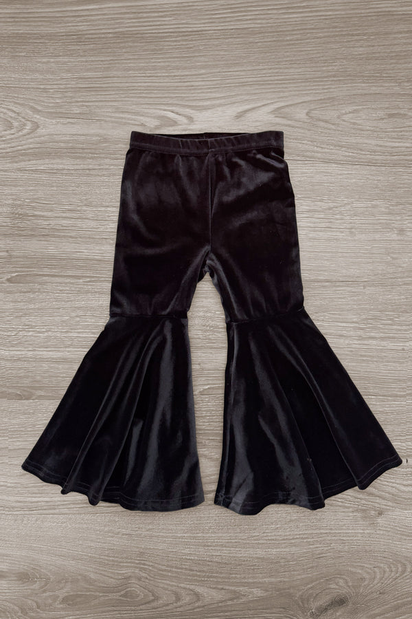 "Boo" Velvet Bell Bottom Set - 6-12 Months - Black velvet bell bottom pants with high waist and wide flared legs on wooden floor background.