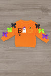 "Boo" Velvet Bell Bottom Set - 6-12 Months - Orange velvet long-sleeve top with black, white, and orange Halloween-themed appliqués and colorful bows on the sleeves.