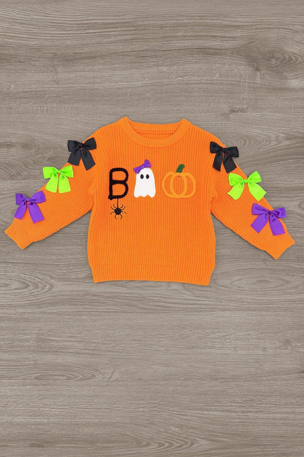 "Boo" Velvet Bell Bottom Set - 6-12 Months - Orange velvet long-sleeve top with black, white, and orange Halloween-themed appliqués and colorful bows on the sleeves.