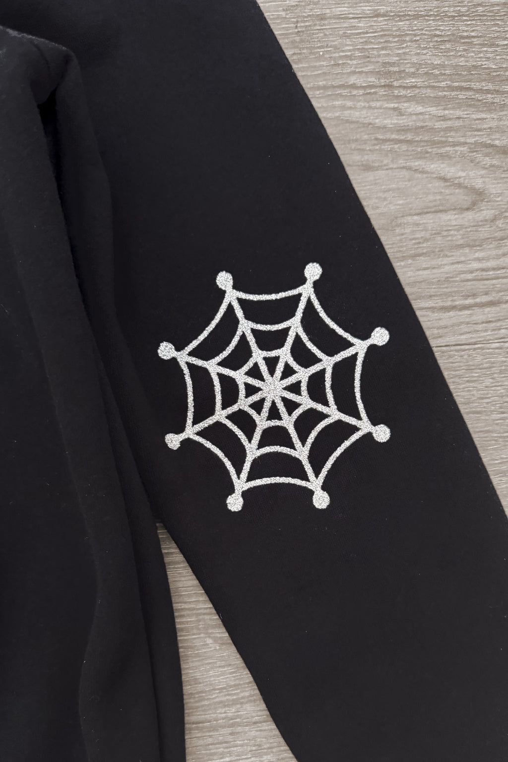 Mom & Me - "Spooky" Ghost Pullover & Denim Pant Set - CHILD-6-12 Months - Black pullover sleeve with white spiderweb graphic printed near the elbow.