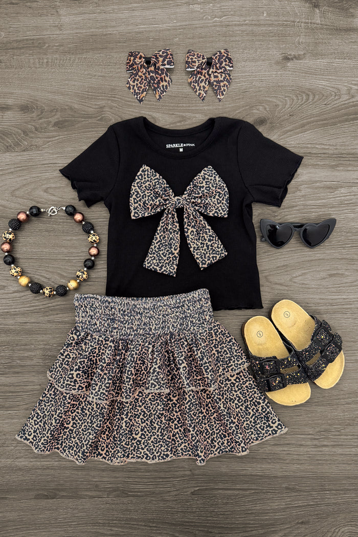 Black Cheetah Print Ruffle Skirt Set - 6-12 Months - Black short-sleeve top with large cheetah print bow paired with matching ruffle skirt, cheetah print hair scrunchies, black.