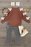 Brown Gemstone Denim Pant Set - 6-12 Months - Brown ribbed knit sweater with white bow accents on sleeves, paired with faded blue flared denim pants and beige ankle boots.