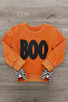 Mom & Me - "Boo" Rust Long Sleeve Top - CHILD-6-12 Months - Rust orange long sleeve toddler top with black "BOO" text and black-and-white striped bow sleeve cuffs.