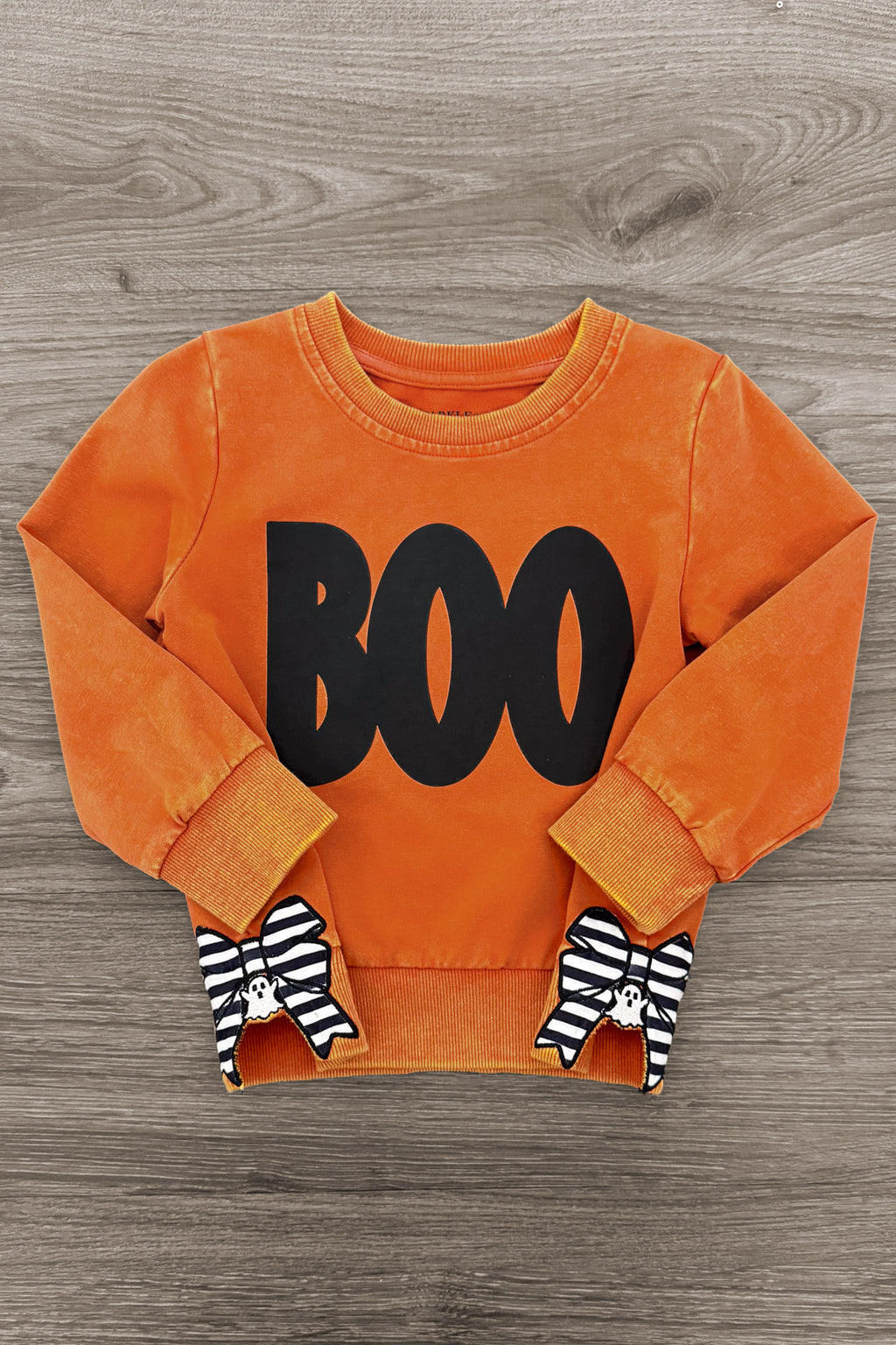 Mom & Me - "Boo" Rust Long Sleeve Top - CHILD-6-12 Months - Rust orange long sleeve toddler top with black "BOO" text and black-and-white striped bow sleeve cuffs.