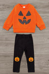Jack O' Lantern Legging Set - 6-12 Months - Orange long-sleeve sweatshirt with a black jack-o'-lantern face and black leggings featuring small pumpkin prints on the.