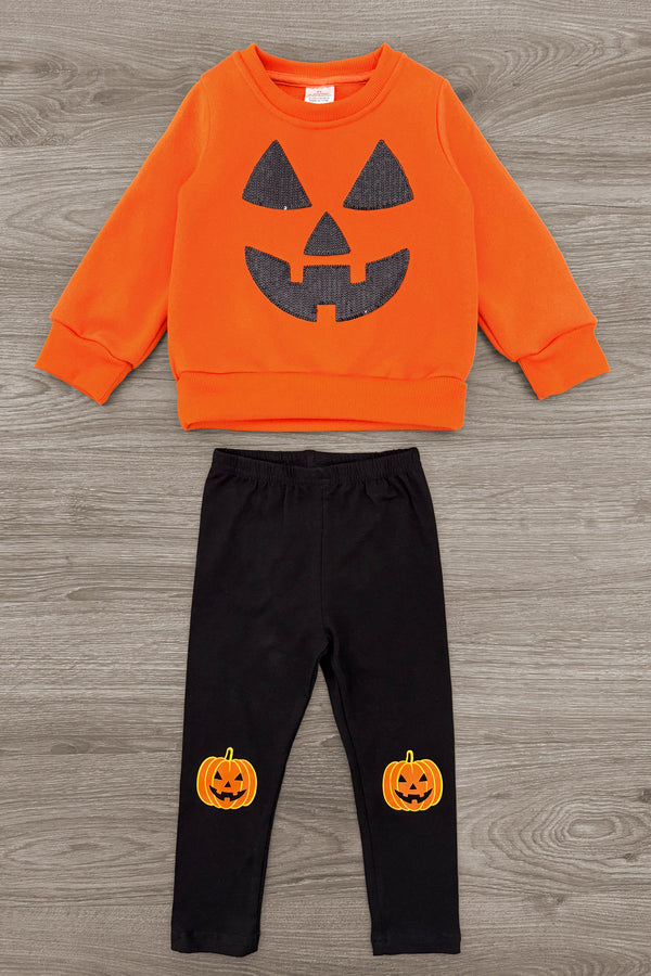Jack O' Lantern Legging Set - 6-12 Months - Orange long-sleeve sweatshirt with a black jack-o'-lantern face and black leggings featuring small pumpkin prints on the.