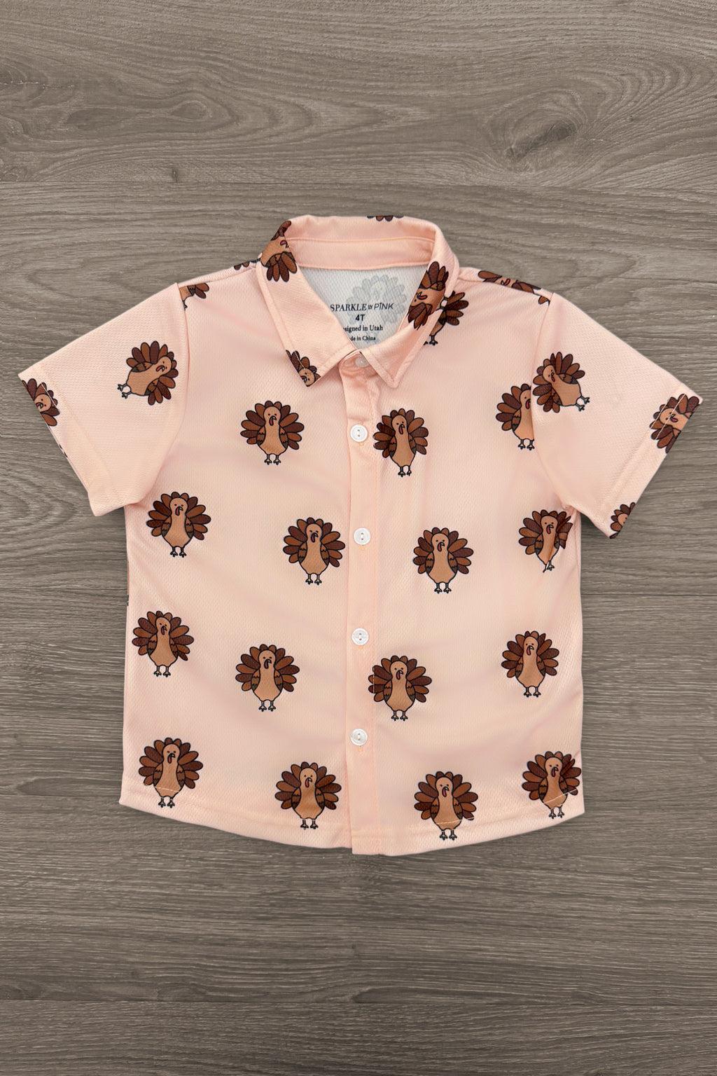 Turkey Button Down Top - 6-12 Months - Light peach short-sleeve button-down shirt with a collar and repeating turkey print.