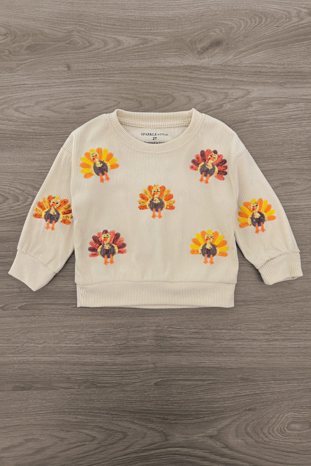 Mom & Me - Corduroy Sequin Turkey Top - CHILD-6-12 Months - Cream long-sleeve sweatshirt with colorful sequin turkey appliqués across the front and sleeves.