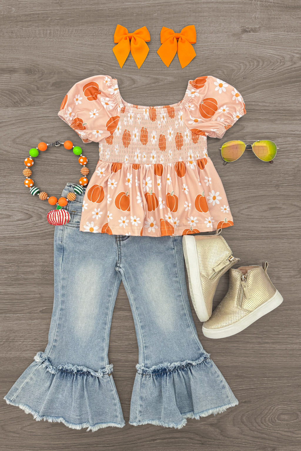 Pumpkin Daisy Denim Bell Bottom Set - 6-12 Months - Orange-and-white floral puff-sleeve top with light blue ruffled denim bell-bottom jeans and matching accessories.