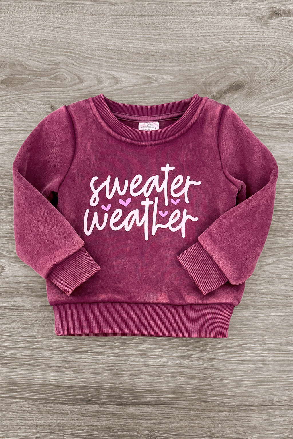 Mom & Me - "Sweater Weather" Acid Wash Pullover - CHILD-6-12 Months - Burgundy acid-wash pullover sweatshirt with ribbed cuffs and hem and white “Sweater Weather” script.
