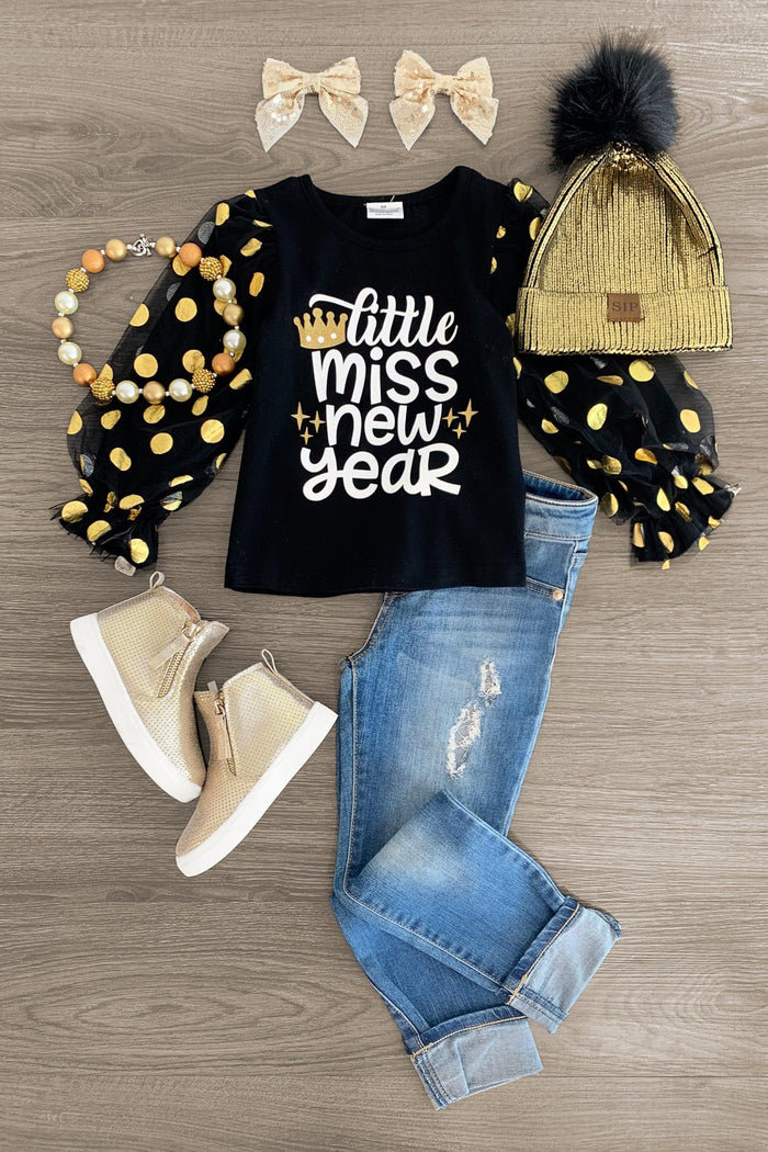 "Little Miss New Year" Black Puff Sleeve Top - 3XS-6-12 Months - Black puff sleeve top with gold polka dots and "Little Miss New Year" text, paired with blue rolled jeans, tan boots, gold.