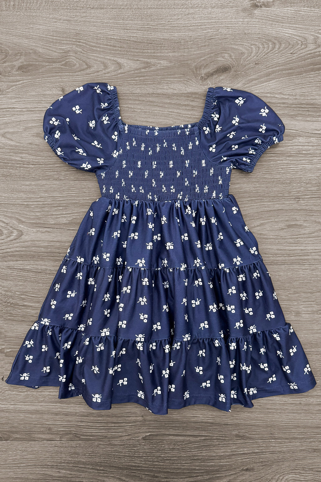 Mom & Me - Navy Floral Dress - CHILD-6-12 Months - Navy blue floral dress with puff sleeves, a smocked bodice, and a gathered skirt.