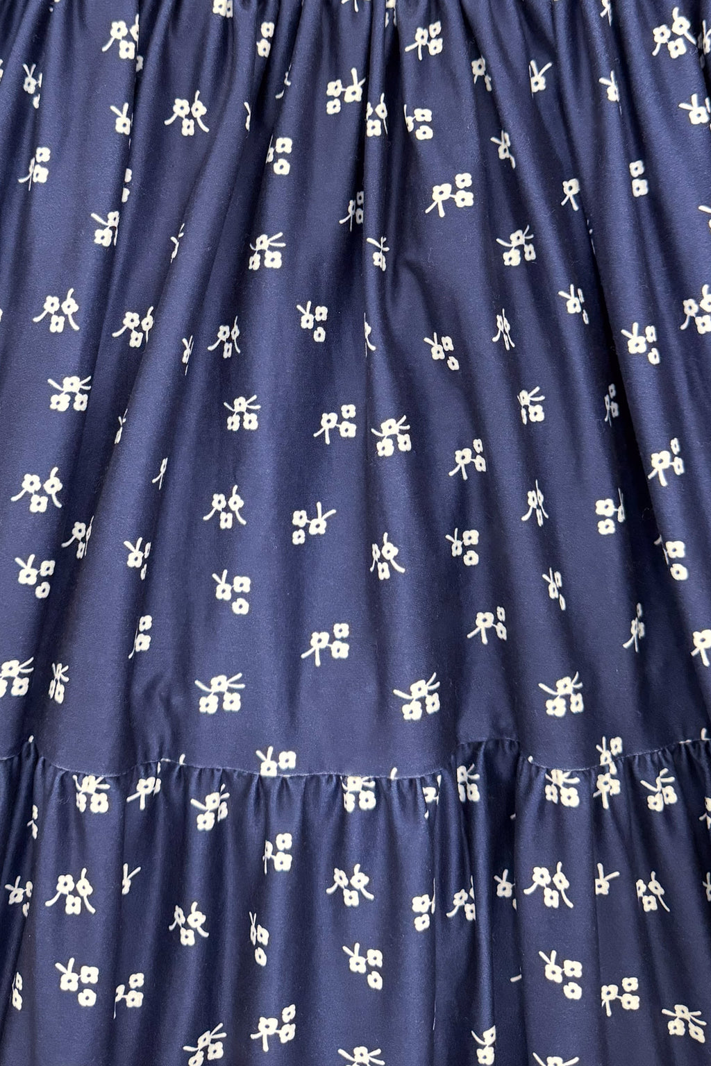 Mom & Me - Navy Floral Dress - CHILD-6-12 Months - Navy dress fabric with a white floral print and gathered tiered ruffle seams.