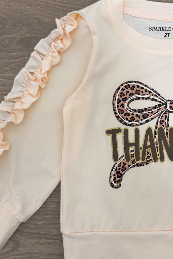"Thankful" Cheetah Bow Pant Set - 6-12 Months - Cream-colored long-sleeve toddler shirt with ruffles on sleeves and cheetah print bow over "Thankful" text.