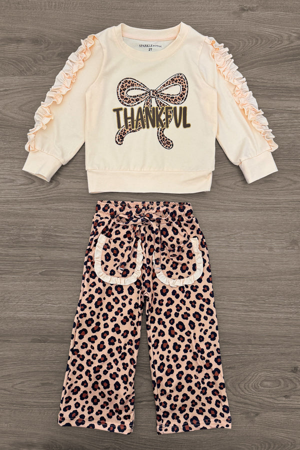 "Thankful" Cheetah Bow Pant Set - 6-12 Months - Cream long-sleeve top with ruffled sleeves and "Thankful" cheetah print bow graphic paired with cheetah print wide-leg pants.