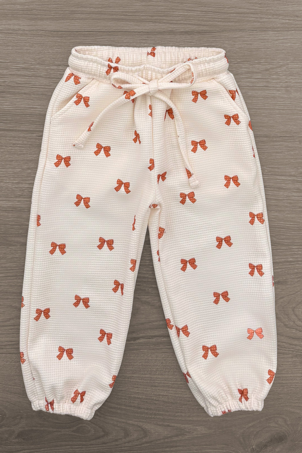 Mom & Me - Waffle Knit Bow Lounge Set - CHILD-6-12 Months - Cream waffle-knit lounge pants with orange bow print, elastic waistband, drawstring, and cuffed ankles.
