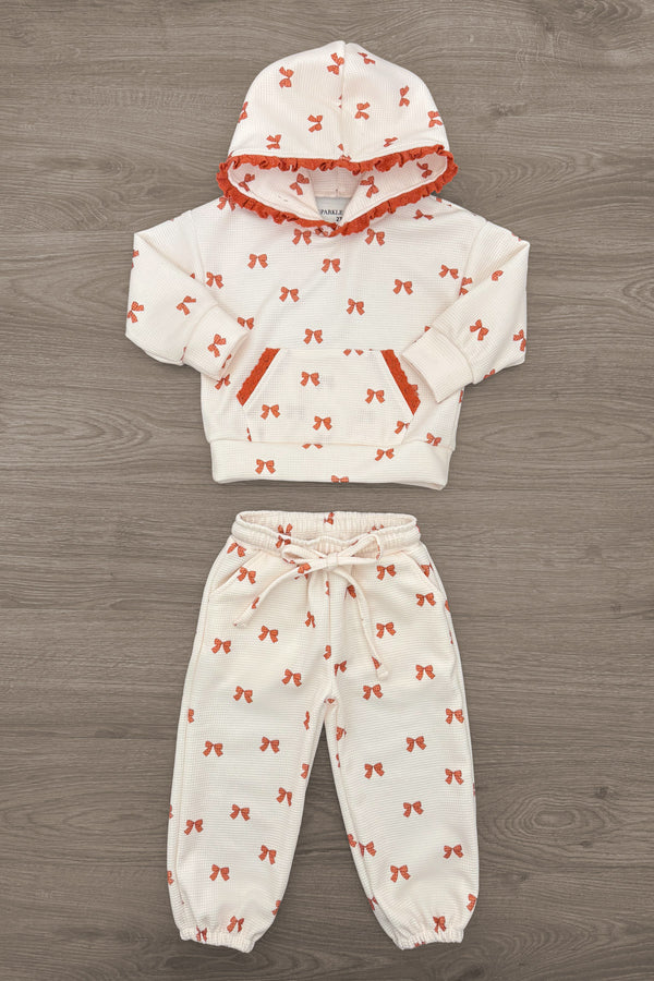 Mom & Me - Waffle Knit Bow Lounge Set - CHILD-6-12 Months - Cream waffle-knit lounge set with orange bow print, featuring a short-sleeve top, drawstring pants, and matching hooded cap.