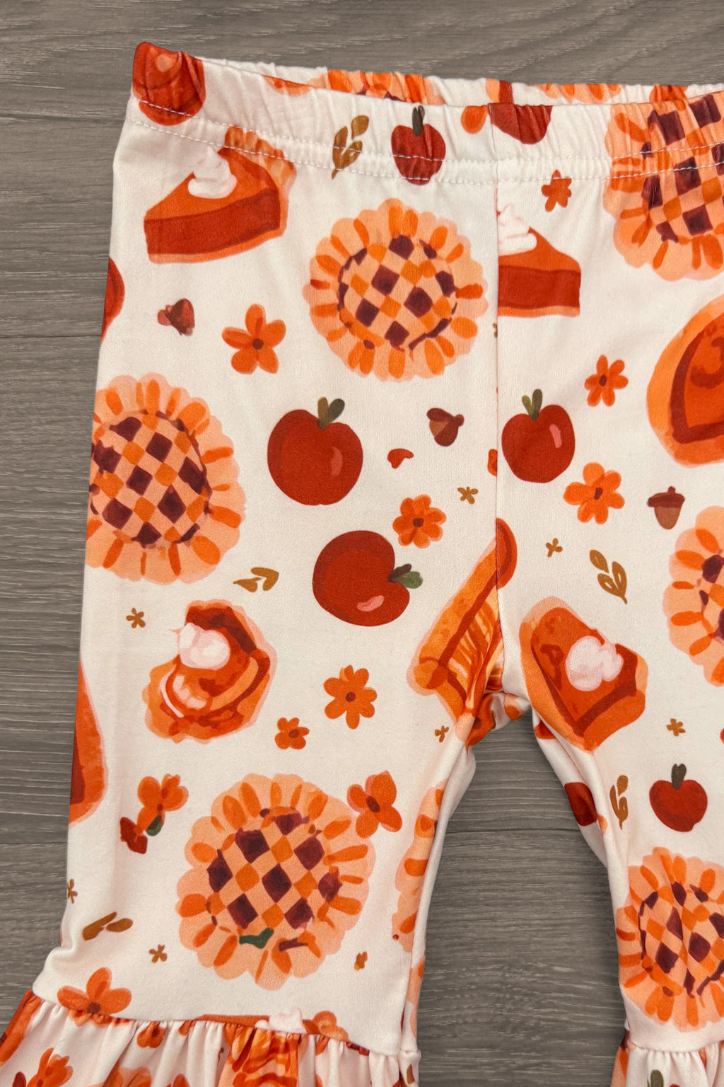 "Yippie Pie Yay!" Bell Bottom Pant Set - 6-12 Months - Cream bell-bottom pants with orange and burgundy pumpkins, pie, and autumn motifs.