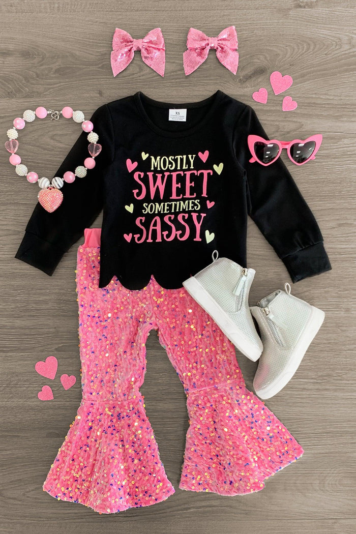 "Mostly Sweet Sometimes Sassy" Sequin Bell Bottom Set - 3XS-6-12 Months - Black long-sleeve top with "Mostly Sweet Sometimes Sassy" in pink and gold glitter paired with pink sequin bell-bottom.