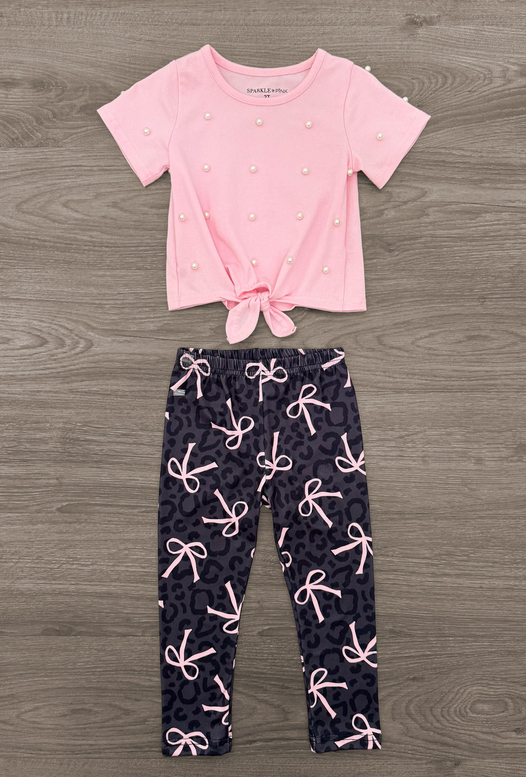 Pink & Black Bow Legging Set - 6-12 Months - Pink short-sleeve top with a knotted hem paired with black leggings covered in pink bows.