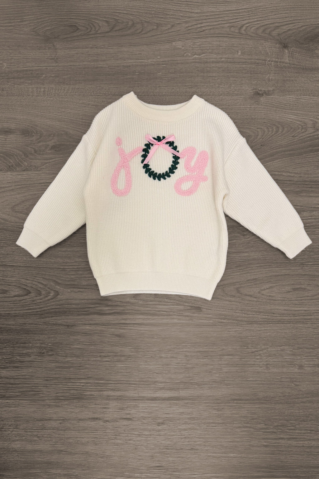 "Joy" Denim Flare Pant Set - 6-12 Months - Cream long-sleeve sweatshirt with pink “Joy” lettering and a teal-and-pink decorative bow design.