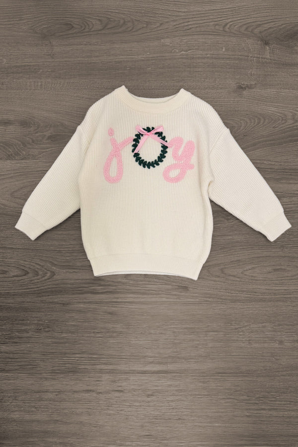 "Joy" Denim Flare Pant Set - 6-12 Months - Cream long-sleeve sweatshirt with pink “Joy” lettering and a teal-and-pink decorative bow design.